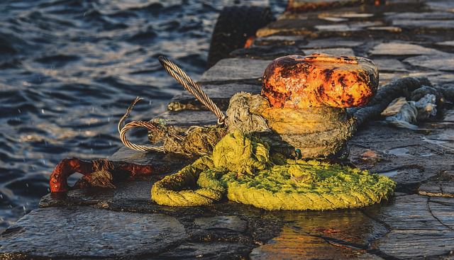 Rusty harbour wall bollard